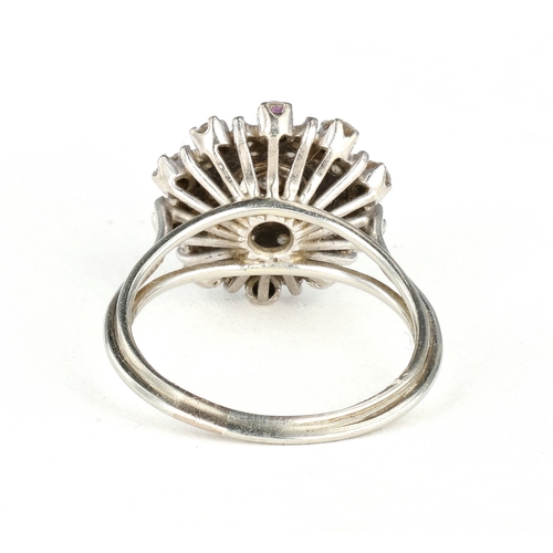 47 - AN 18 CARAT WHITE GOLD DIAMOND CLUSTER RING
The illusion set stones with the largest to the centre, ... 