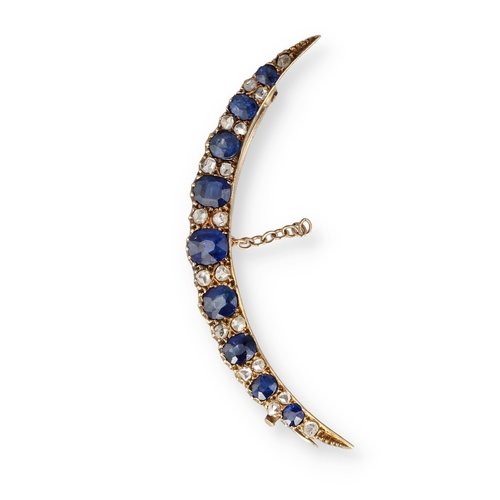 5 - AN EDWARDIAN 15 CARAT GOLD SAPPHIRE AND DIAMOND CRESCENT SHAPE BROOCH
The nine graduated oval sapphi... 