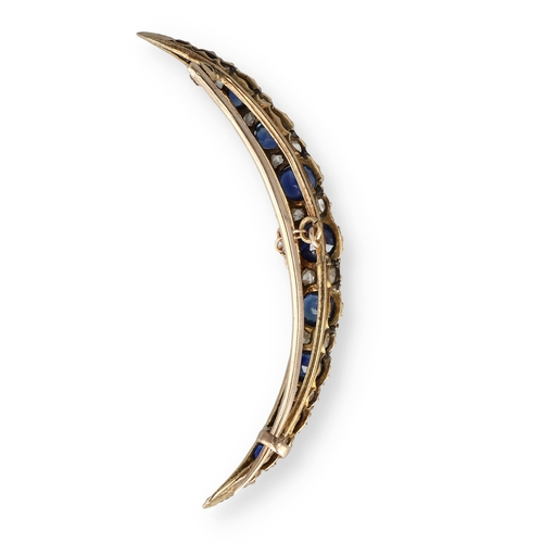 5 - AN EDWARDIAN 15 CARAT GOLD SAPPHIRE AND DIAMOND CRESCENT SHAPE BROOCH
The nine graduated oval sapphi... 