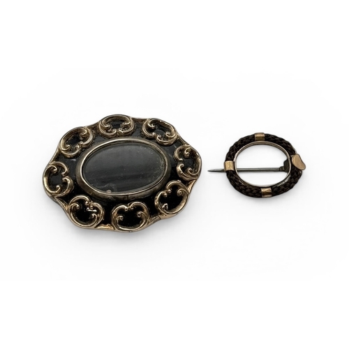 52 - A VICTORIAN MEMEMTO MORI GOLD AND BLACK ENAMEL BROOCH, TOGETHER WITH A SIMILAR GOLD PLATED MOURNING ... 