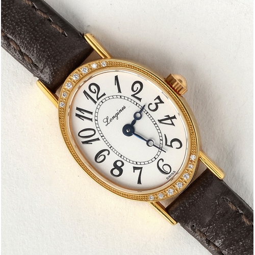 27 - A LADIES 18CT GOLD LONGINES WRIST WATCH SET WITH DIAMONDS
With brown leather strap
Gross weight incl... 