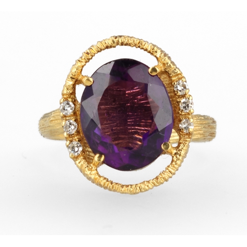 34 - AN 18CT TEXTURED GOLD RING SET WITH AMETHYST AND DIAMONDS
Weight: 6.6gms