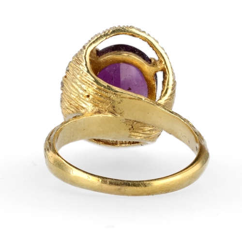 34 - AN 18CT TEXTURED GOLD RING SET WITH AMETHYST AND DIAMONDS
Weight: 6.6gms