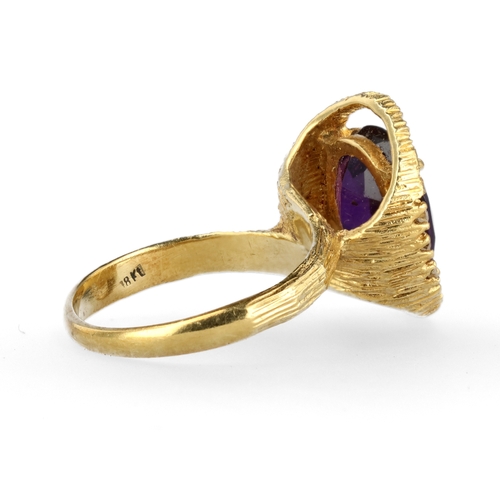 34 - AN 18CT TEXTURED GOLD RING SET WITH AMETHYST AND DIAMONDS
Weight: 6.6gms