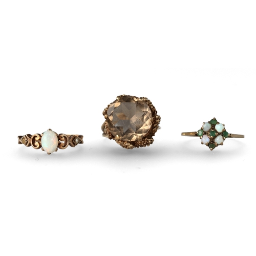 39 - A GROUP OF THREE 9 CARAT GOLD STONE SET DRESS RINGS
The first with a smokey quartz in a raised abstr... 