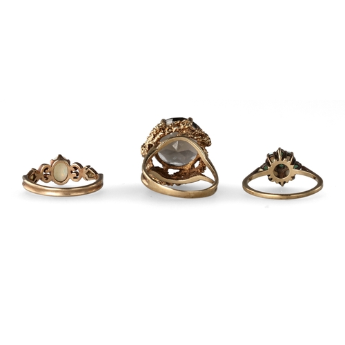 39 - A GROUP OF THREE 9 CARAT GOLD STONE SET DRESS RINGS
The first with a smokey quartz in a raised abstr... 
