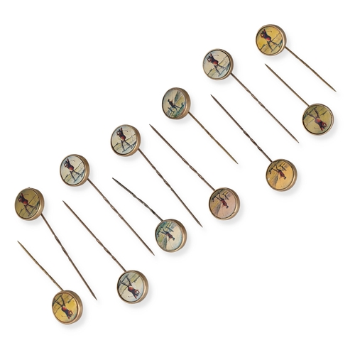 45 - A SET OF TWELVE 9CT GOLD NOVELTY GOLF STICK PINS
Each with printed roundel depicting a golfer mid-sw... 