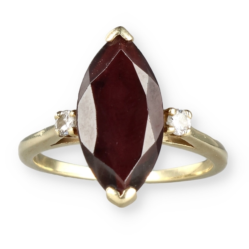 49 - A 14 CARAT GOLD GARNET AND DIAMOND THREE-STONE DRESS RING
The marquise cut garnet flanked by two bri... 