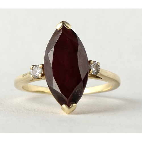 49 - A 14 CARAT GOLD GARNET AND DIAMOND THREE-STONE DRESS RING
The marquise cut garnet flanked by two bri... 