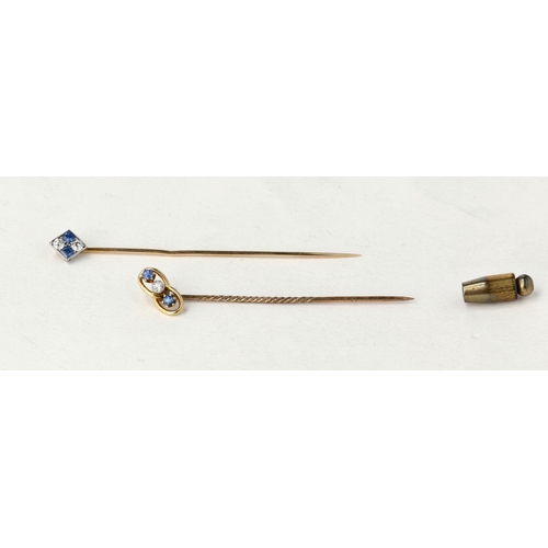79 - A MATCHED PAIR OF 9CT GOLD STICK PINS SET WITH SAPPHIRES AND DIAMONDS
Total weight: 2.3gms
In blue R... 