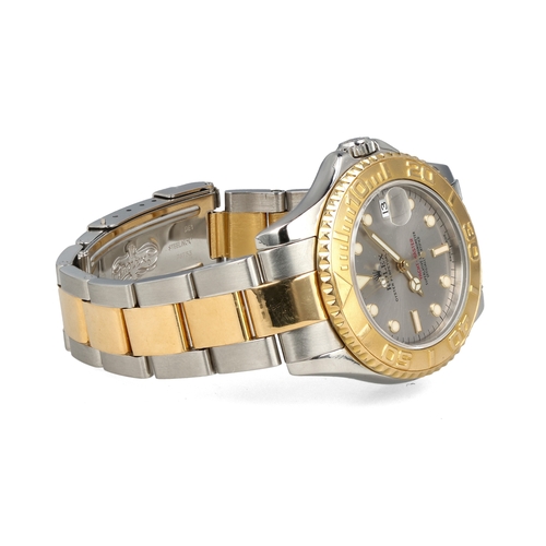 93 - ROLEX: A GENTLEMAN'S18CT GOLD AND STEEL YACHT-MASTER WATCH
With Rolex papers.
 