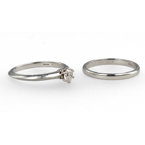 96 - TIFFANY & CO: A PLATINUM SOLITAIRE DIAMOND RING TOGETHER WITH A MATCHING PLATINUM WEDDING BAND
W... 