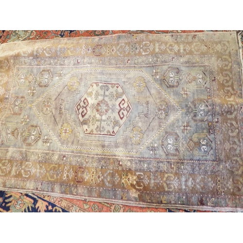 599 - An Oriental Kayam geometrically woven blue ground rug 178 cm x 109 cm