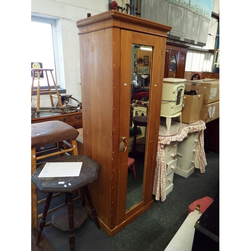 590 - A stripped pine wardrobe fitted with a single mirrored door