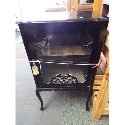 605 - A Victorian ebonised display cabinet, the serpentine top over a fretwork glazed door and raised on c... 