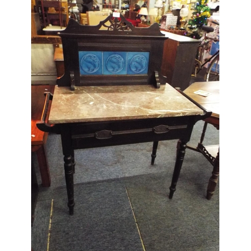 503 - An Arts and Crafts marble top and tiled back wash standing having frieze drawer resting on turned su... 