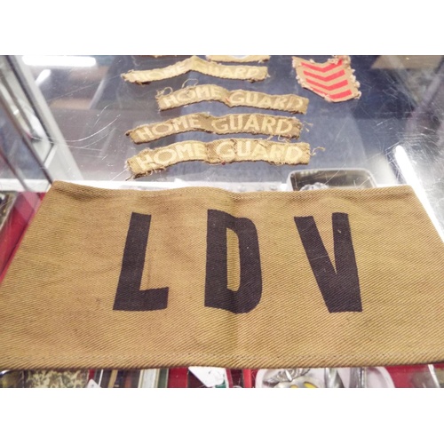 77 - A selection of Kent Home Guard Insignia an LDV arm band, WWII Boy Scouts woolen shirt, badge and boo... 