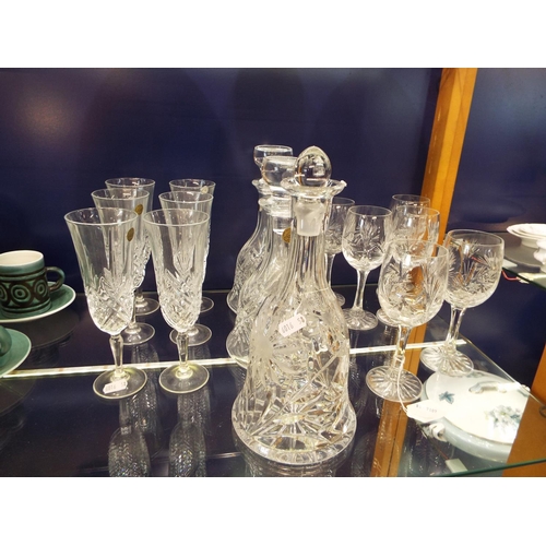41 - A set of six Rock Crystal champagne flutes together with three crystal decanters and six wine glasse... 