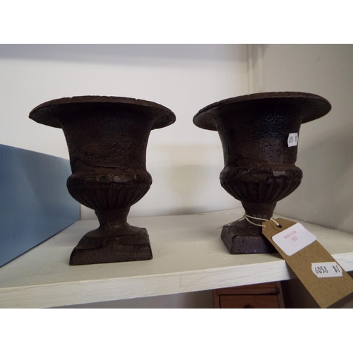 321 - A pair of heavy cast metal miniature urns