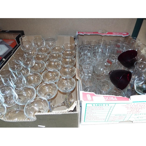 445 - A mixed selection of assorted glassware in two boxes to include tankards, pint glasses, wine, Babych... 