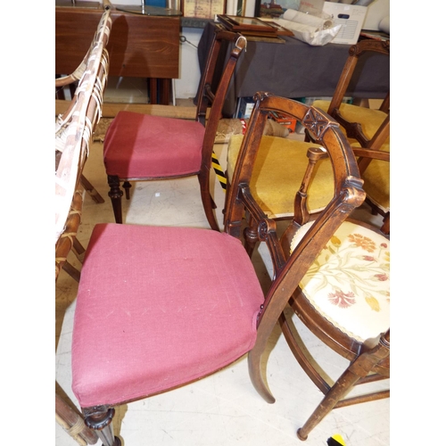 462 - A pair of Victorian dining chairs having carved back rails, pink upholstered seats and turned fluted... 