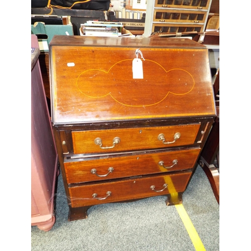 644 - An Edwardian mahogany cross-banded bureau the fall flap enclosing inner compartments above three gra... 