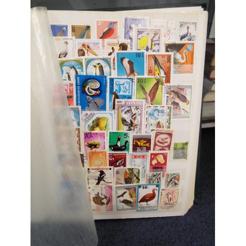 62 - Four stamp albums to include Argentina, Cuba, Dubai, Magyar, Colombia etc