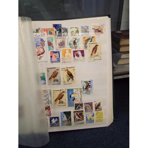 62 - Four stamp albums to include Argentina, Cuba, Dubai, Magyar, Colombia etc