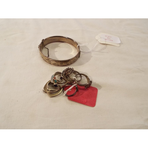 124 - A silver cuff bangle with engine turned decoration safety chain a/f and eight silver rings inset wit... 