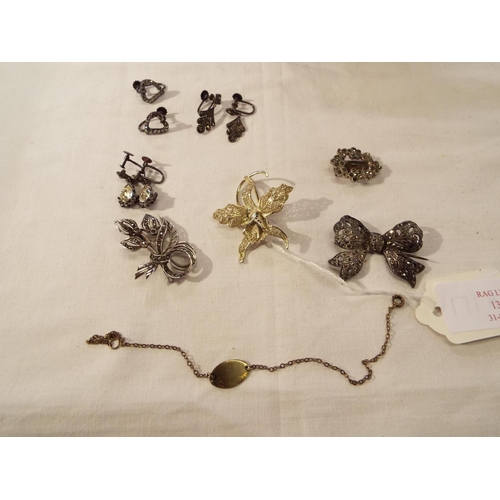 136 - A mixed selection of silver items to include a marcasite set bow brooch, orchid brooch, earrings, br... 