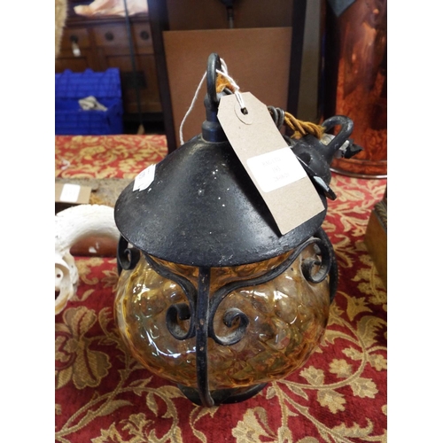 193 - A hanging interior metal lamp with an amber coloured glass