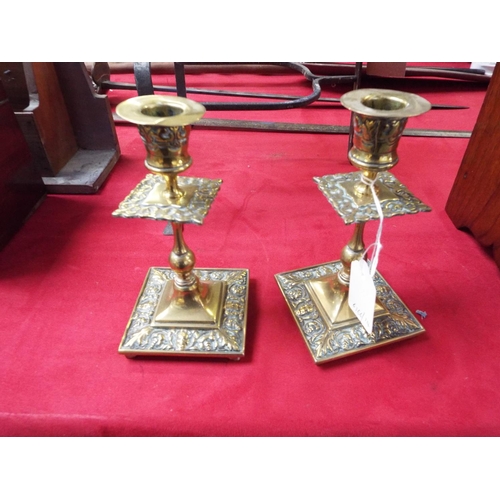 204 - A pair of Victorian candlesticks with mask and floral decoration