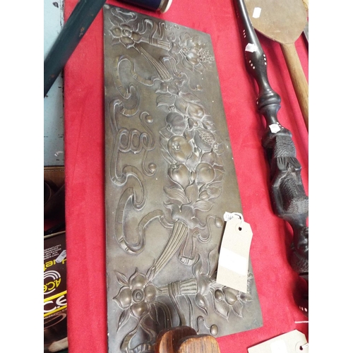 228 - A bronze plaque having embossed floral and fruit decoration