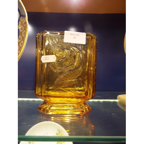 39 - An amber coloured art glass vase with raised female figure