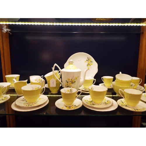 42 - A Royal Albert bone china yellow glazed and floral decorated tea set