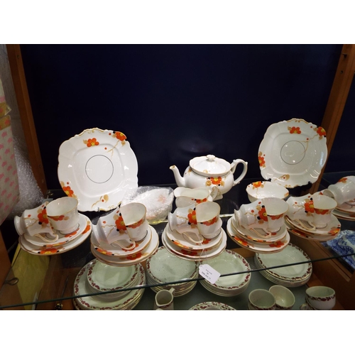 50 - A part tea service with hand printed floral decoration