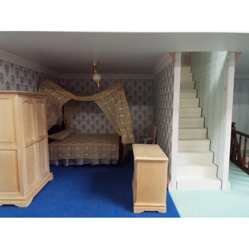 516 - A Victorian dolls house with electrics elaborately furnished, overall measurements 42