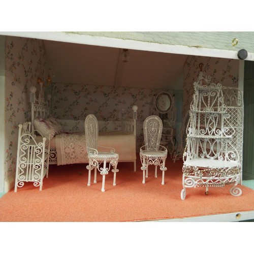 516 - A Victorian dolls house with electrics elaborately furnished, overall measurements 42