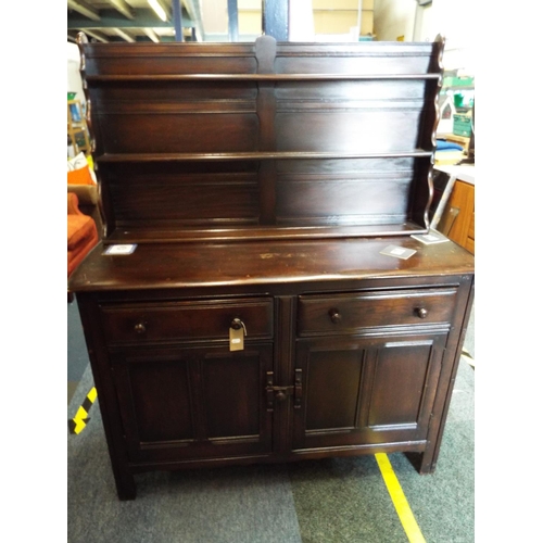 442 - An Ercol dresser the top having three plate racks above two short drawers with cupboard under