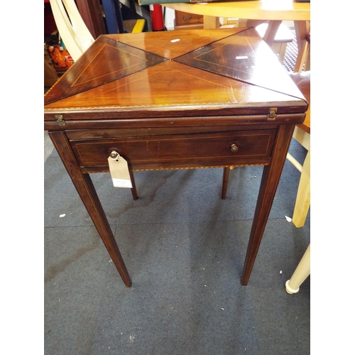 724 - An Edwardian rosewood and boxwood strung envelope games table, the hinge flaps enclosing green baize... 