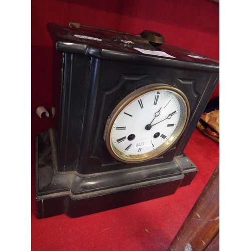 235 - A vintage slate mantel clock the dial having Roman numerals, with pendulum and key