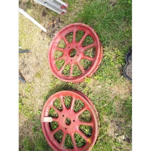 551 - Two vintage cast metal wagon wheels