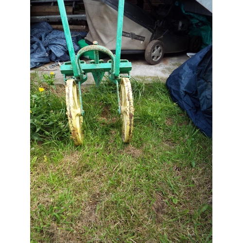 560 - A vintage wooden and cast metal two wheeled line maker