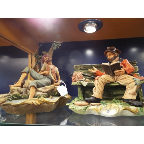 34 - A Capodimonte figurine of a 'Tramp resting on a bench' and a 'Fisherman and his Catch' A/F