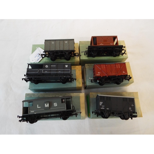 148 - A Mainline GWR fruit van, a Hornby British Rail meat van, an Airfix LMS guards van, a Hornby British... 