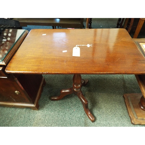 627 - A mahogany oblong snap top side table resting on tri-form base