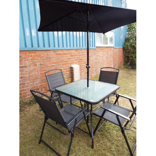 479 - A garden glass top table and a set of four chairs with parasol