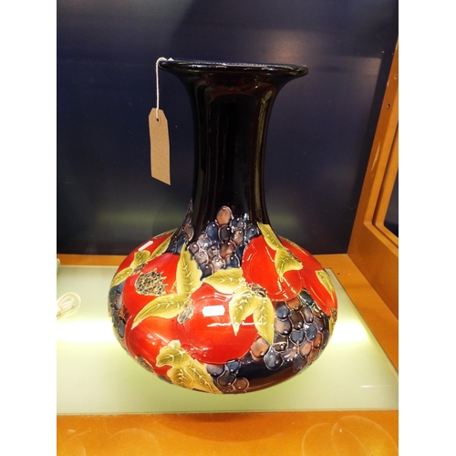 45 - A baluster vase in the style of  Moorcroft with peaches and damson decoration, signed to base 16