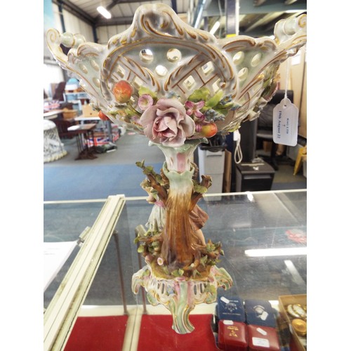 7 - A German porcelain table centre piece the basket having applied fruit and floral decoration, the bod... 