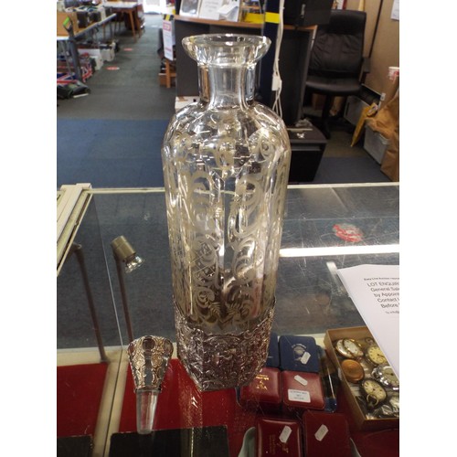 24 - A good quality acid etched decanter with silver sleeve and stopper having ornate decoration